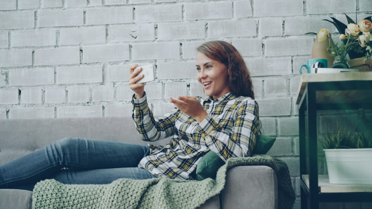 Young woman on a video call from her couch