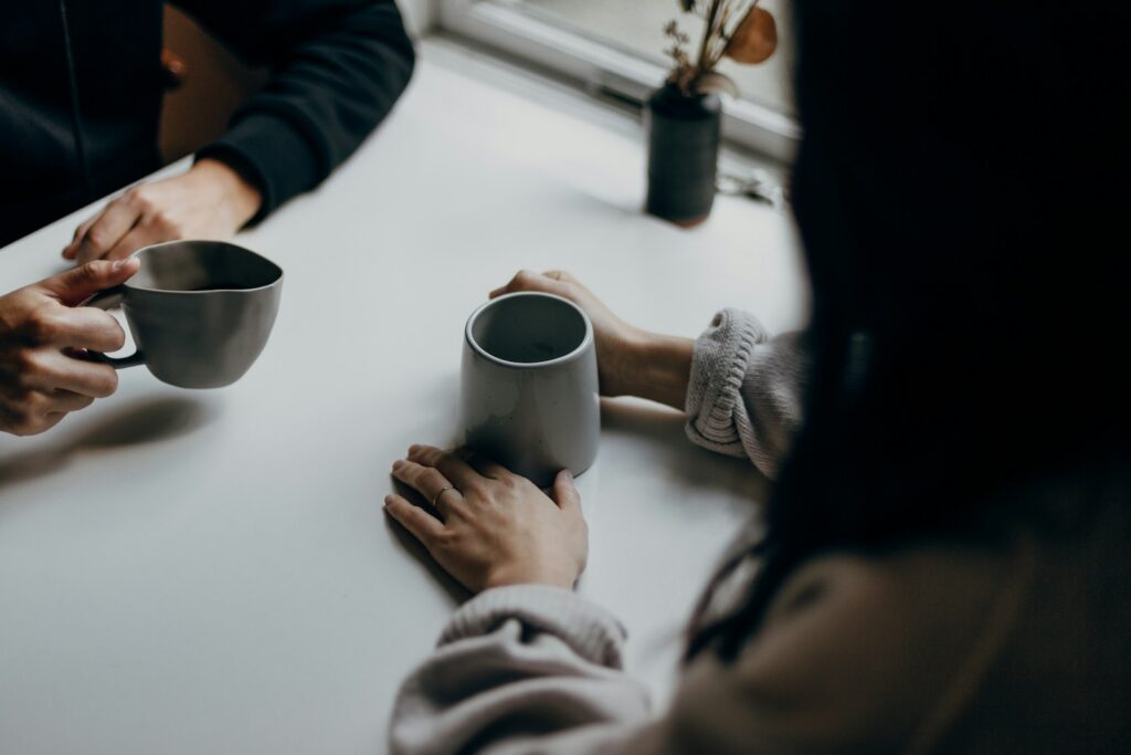 Two people sharing a coffee at a table