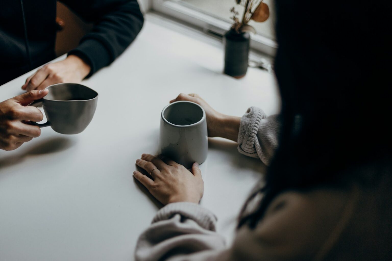 Two people sharing a coffee at a table