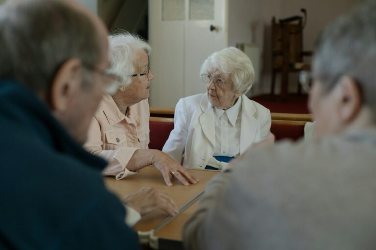 Older adults sitting around a table having a conversation