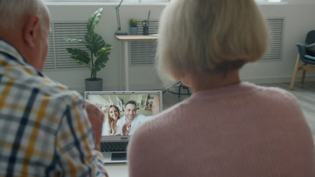Senior woman on a video call with her family on a laptop at home